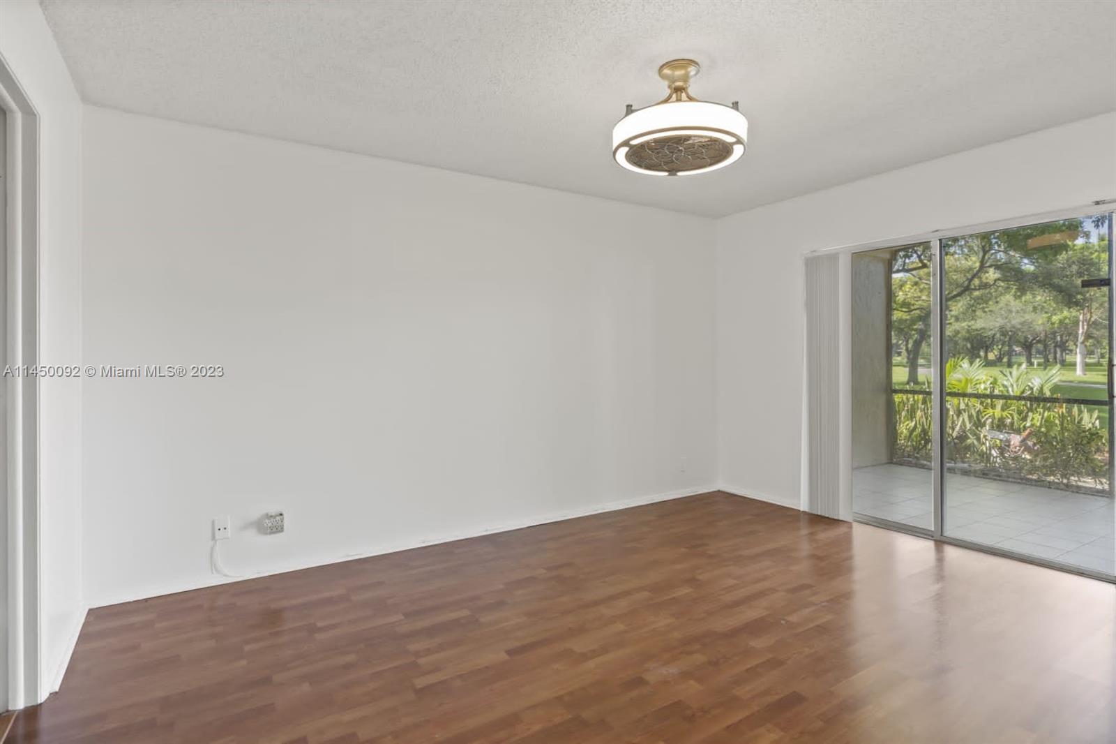 11671 Timbers Way Boca Raton, FL 33428 - Photo 13 of 25 an empty room with wooden floor and windows