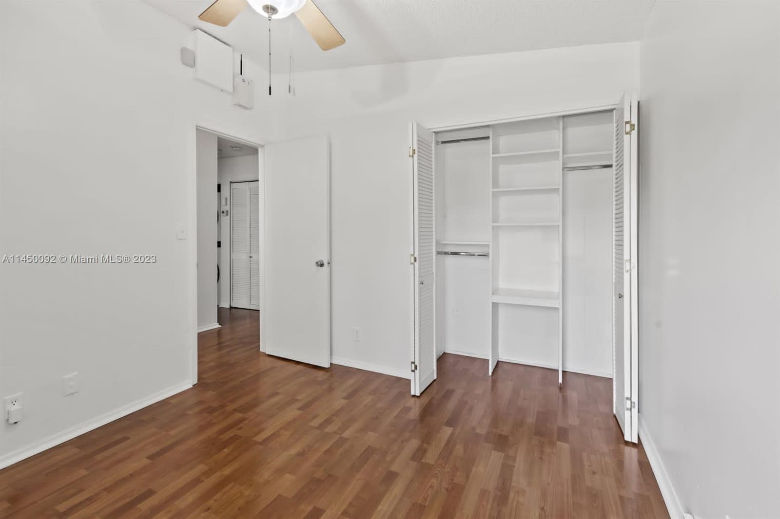 11671 Timbers Way Boca Raton, FL 33428 - Photo 15 of 25 wooden floor in an empty room with a window