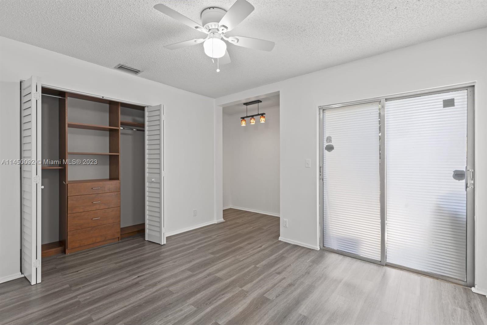 11671 Timbers Way Boca Raton, FL 33428 - Photo 16 of 25 an empty room with wooden floor closet and windows