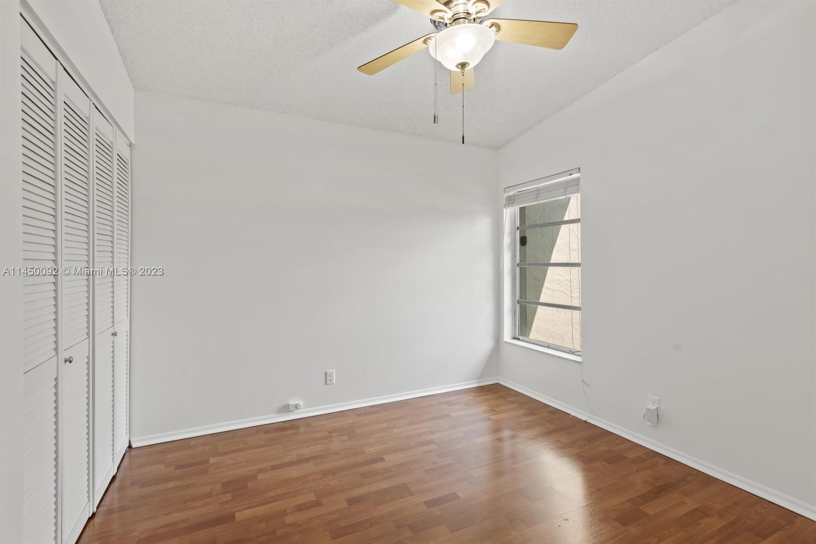 11671 Timbers Way Boca Raton, FL 33428 - Photo 17 of 25 wooden floor in an empty room with a window