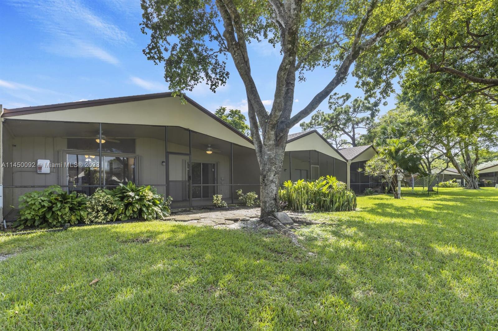 11671 Timbers Way Boca Raton, FL 33428 - Photo 19 of 25 a front view of a house with garden