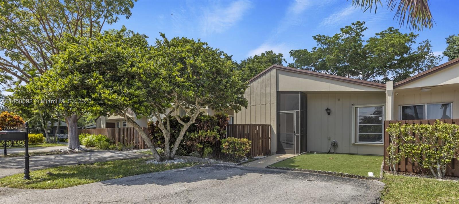 11671 Timbers Way Boca Raton, FL 33428 - Photo 2 of 25 a front view of a house with garden