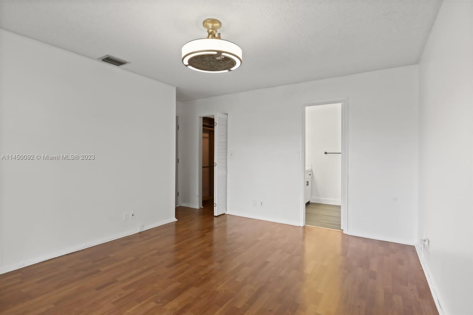 11671 Timbers Way Boca Raton, FL 33428 - Photo 7 of 25 a view of an empty room with wooden floor