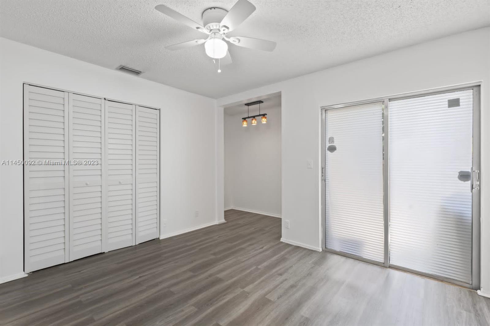 11671 Timbers Way Boca Raton, FL 33428 - Photo 8 of 25 an empty room with wooden floor closet fan and windows