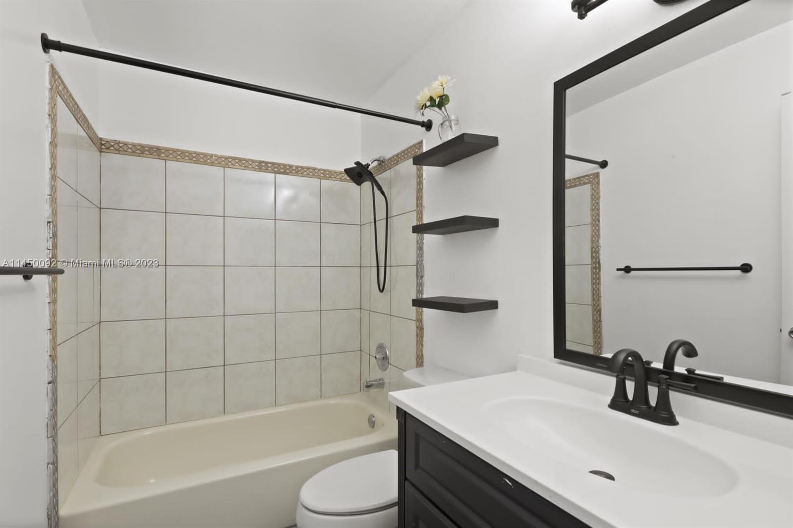 11671 Timbers Way Boca Raton, FL 33428 - Photo 10 of 25 a bathroom with a sink mirror toilet and bathtub
