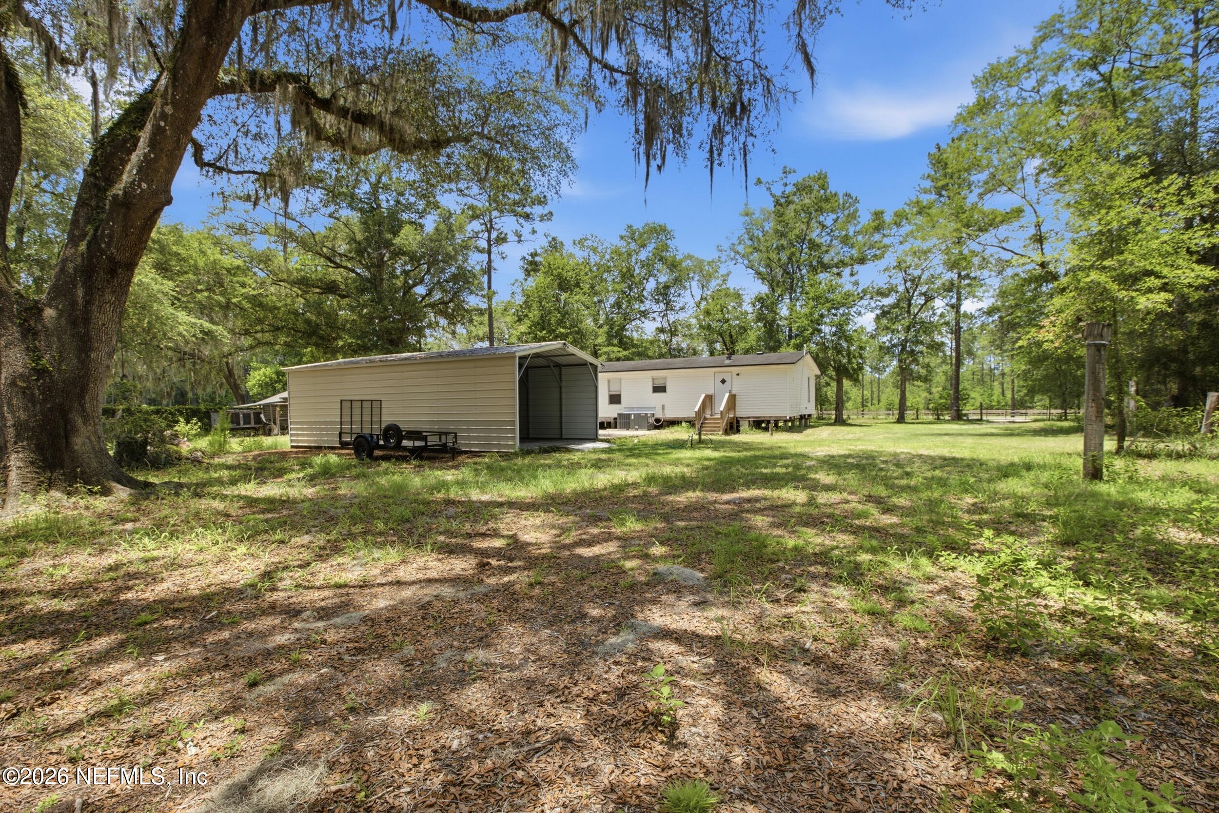 5667 Long Branch Cemetery Road Jacksonville, FL 32234 - Photo 19 of 24 a view of a house with yard and a tree