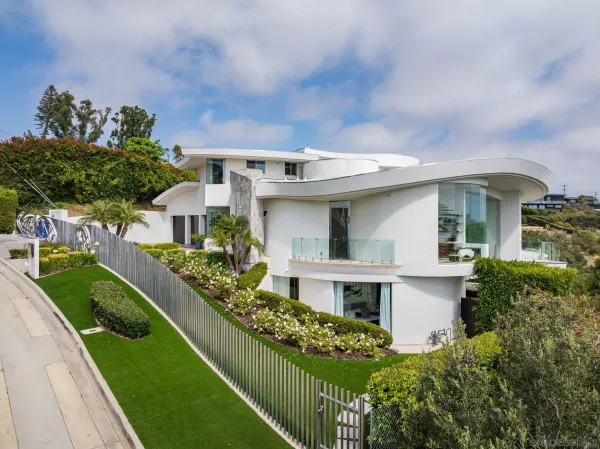 a front view of a house with a garden