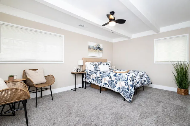 a bedroom with a bed chair and a chandelier