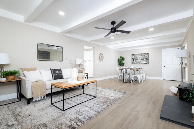 a living room with furniture and a wooden floor