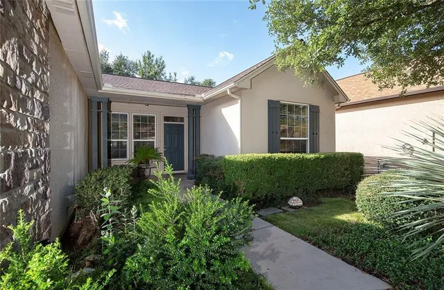 a front view of a house with garden