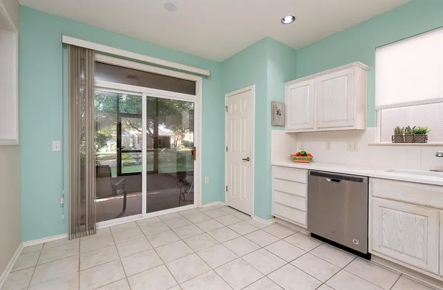 a view of a porch with chairs and backyard