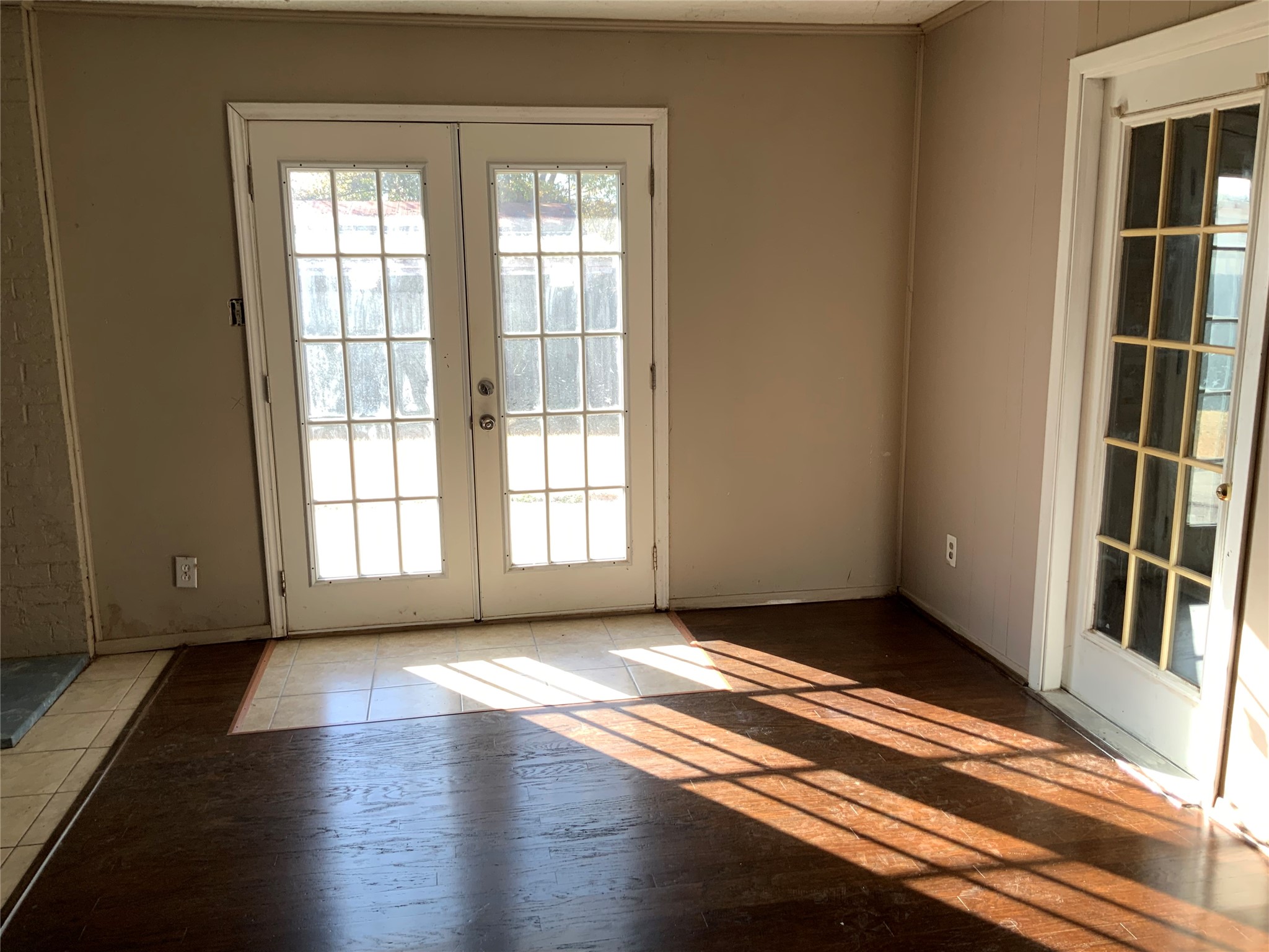 301 Travis Street Baytown, TX 77520 - Photo 14 of 37 Family room double doors go outside and door to the right goes to garage