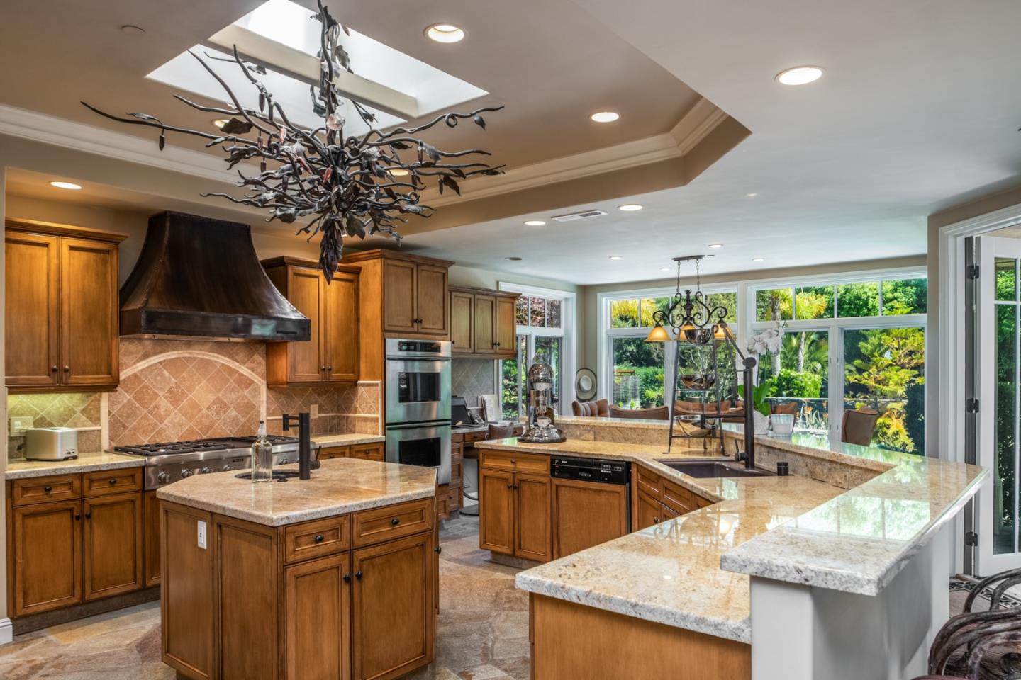 8630 River Meadows Road Carmel, CA 93923 - Photo 11 of 50 a kitchen with stainless steel appliances granite countertop a sink a stove and a refrigerator