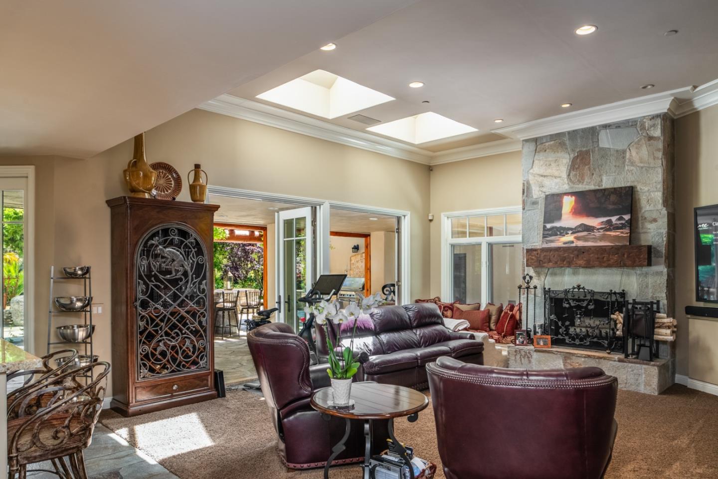 8630 River Meadows Road Carmel, CA 93923 - Photo 14 of 50 a living room with furniture a fireplace and a flat screen tv