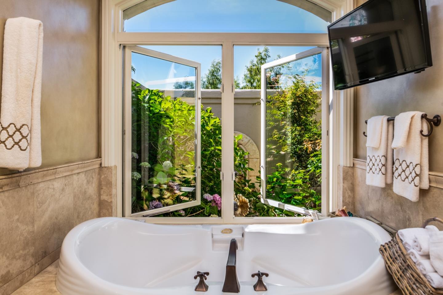 8630 River Meadows Road Carmel, CA 93923 - Photo 21 of 50 a white bath tub sitting in front of a window