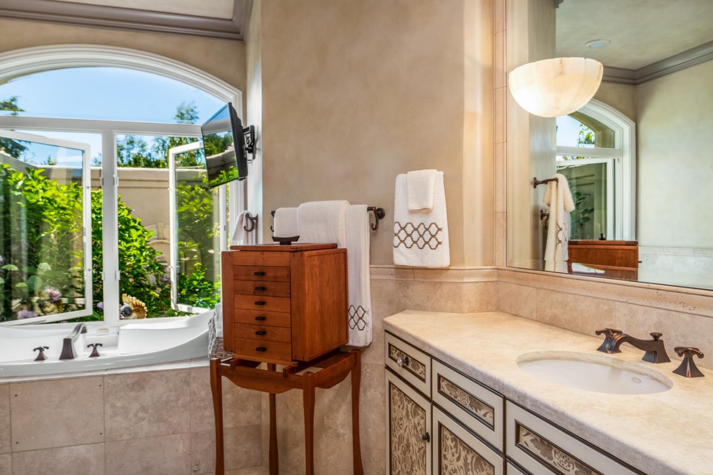 8630 River Meadows Road Carmel, CA 93923 - Photo 22 of 50 a bathroom with a granite countertop sink and a mirror