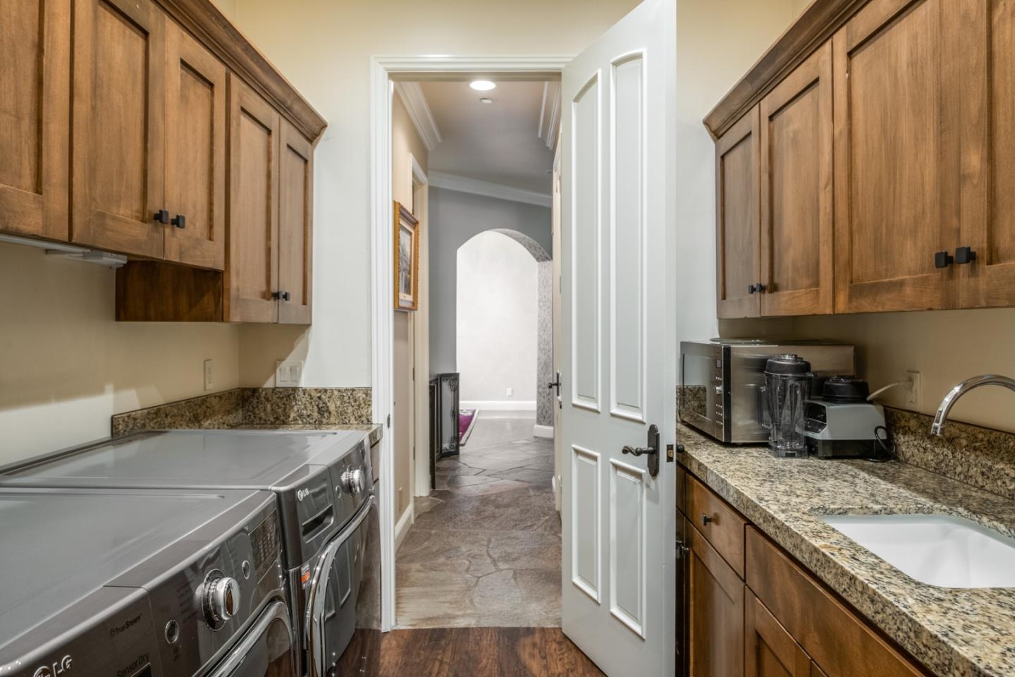 8630 River Meadows Road Carmel, CA 93923 - Photo 27 of 50 a kitchen with a sink stove and cabinets
