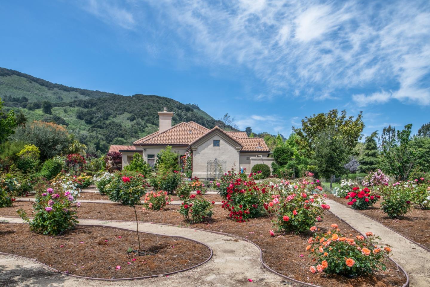 8630 River Meadows Road Carmel, CA 93923 - Photo 44 of 50 a view of a garden with flowers and a pathway