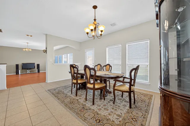 a view of a dining room with furniture and chandelier