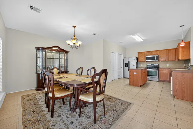 a dining room with furniture and chandelier