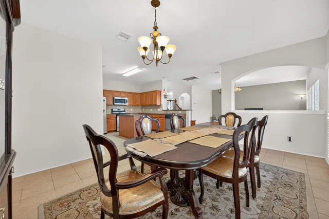 a view of a dining room with furniture and chandelier