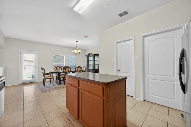a kitchen with stainless steel appliances granite countertop a refrigerator and a stove