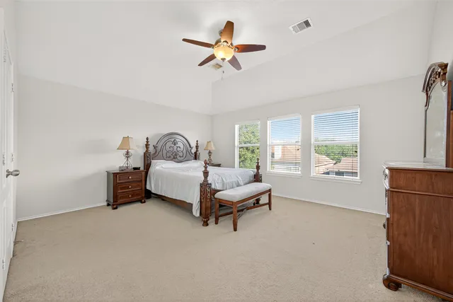 a living room with furniture ceiling fan and a window