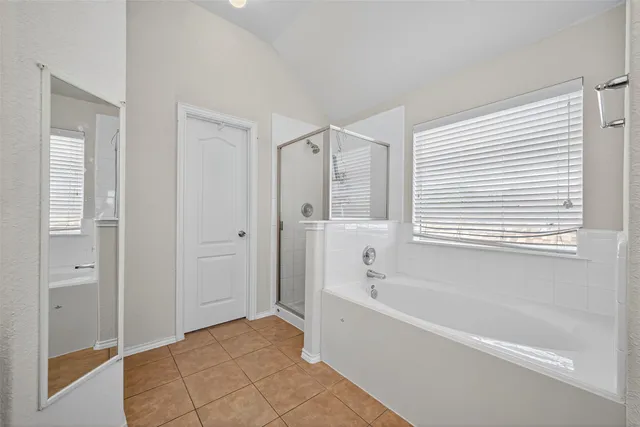 a bathroom with a bathtub and a shower