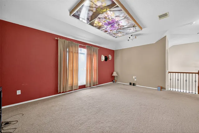 an empty room with a painting on the wall