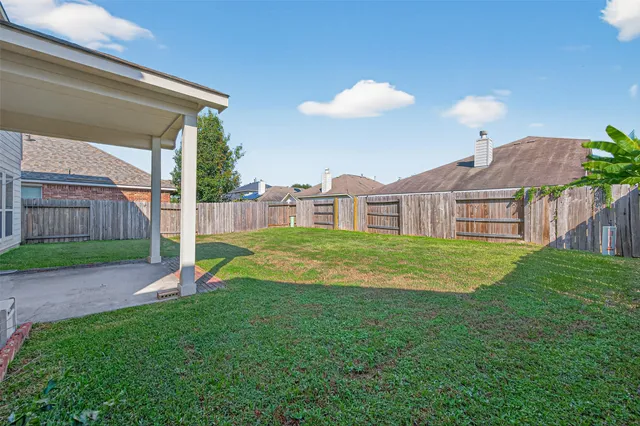 a view of a house with a backyard