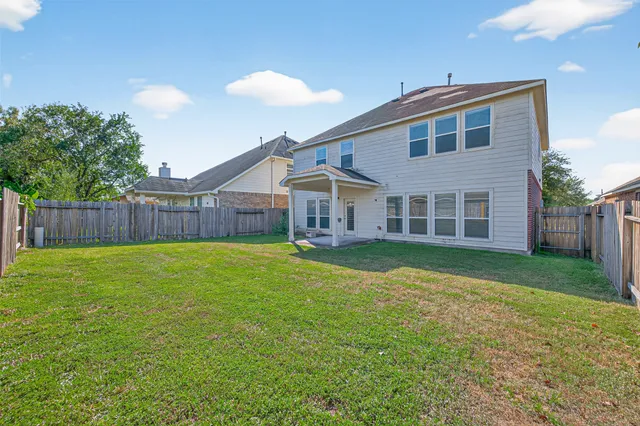 a view of a house with a backyard