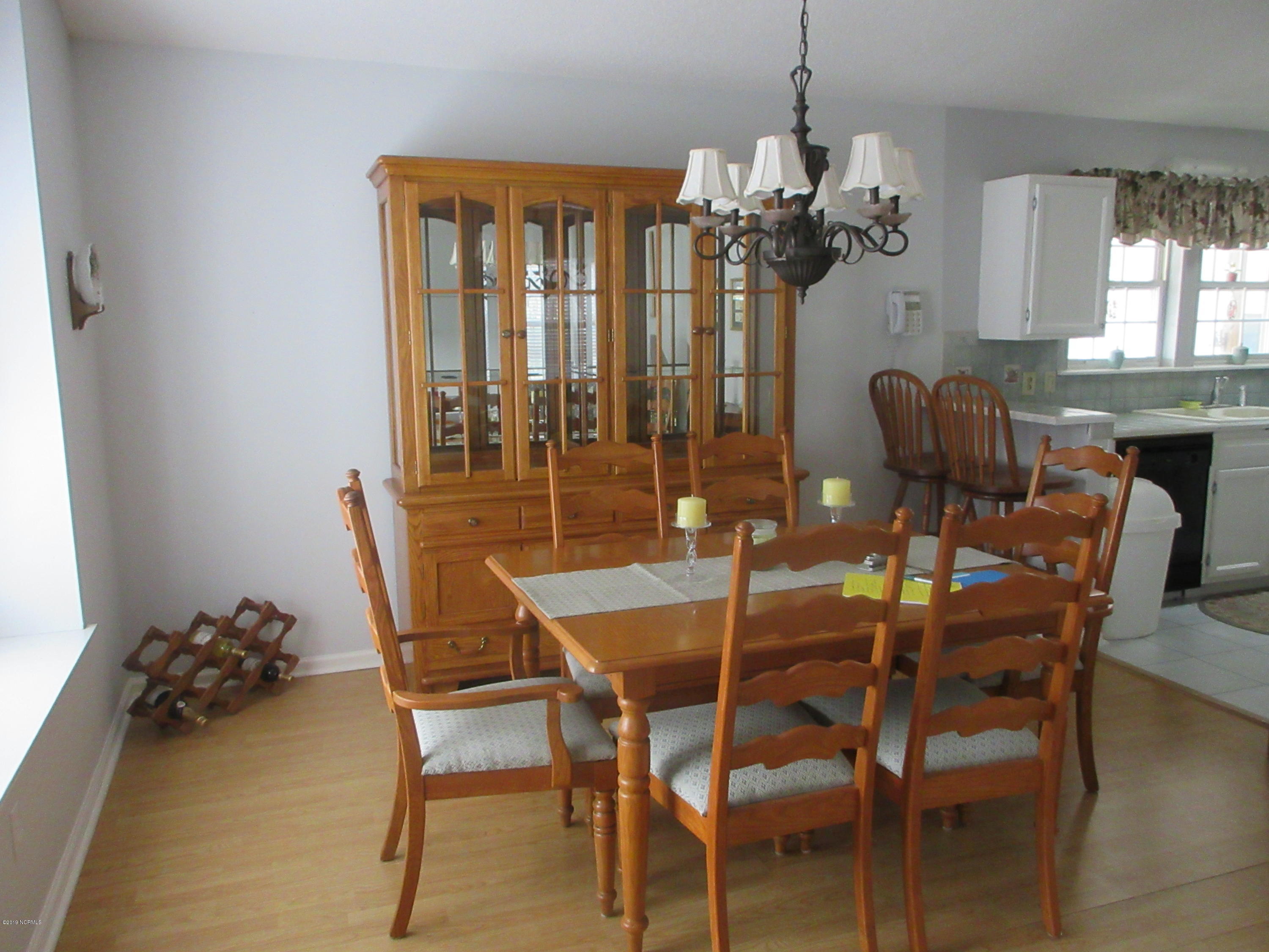 399 Deer Path Calabash, NC 28467 - Photo 20 of 29 DINING ROOM LARGE AND OPEN LAMINATE FLOOR