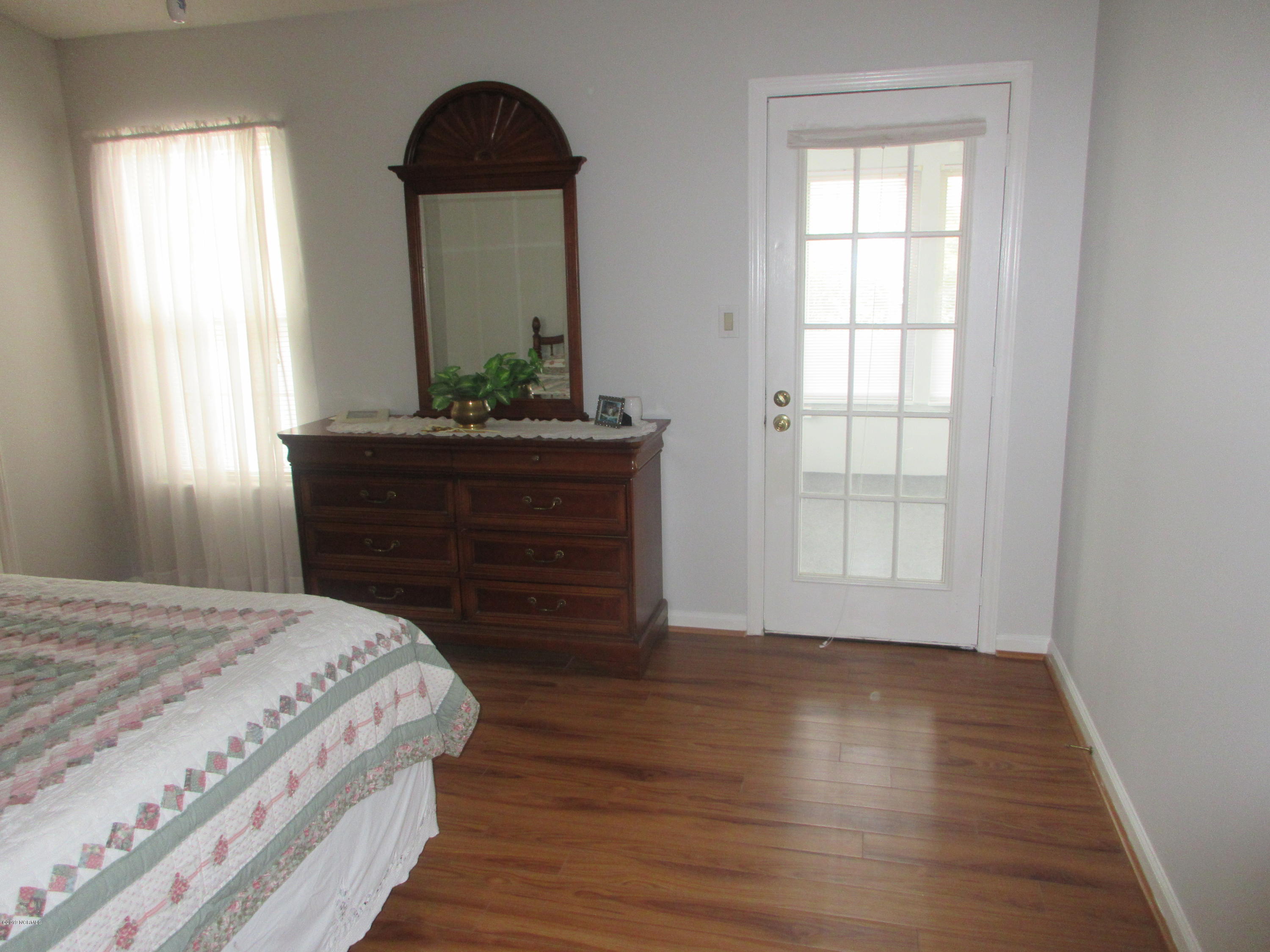 399 Deer Path Calabash, NC 28467 - Photo 10 of 29 MASTER BEDROOM WITH DOOR LEADING TO CAROLINA ROOM