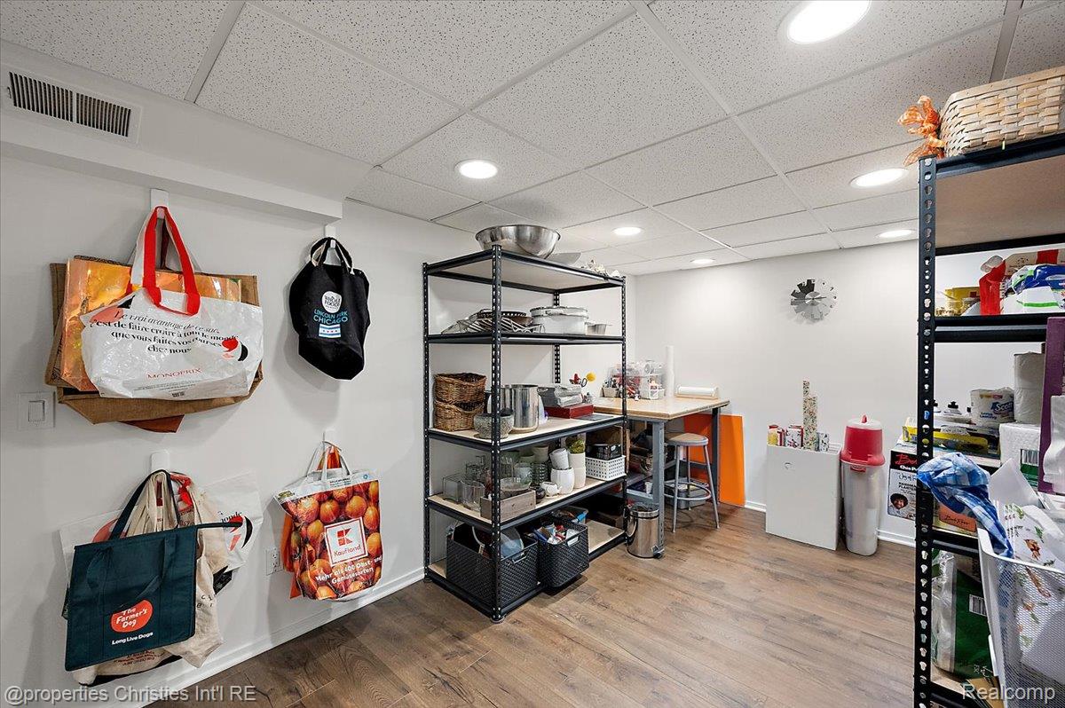 528 Covington Road Bloomfield Hills, MI 48301 - Photo 57 of 75 Finished basement space featuring recessed lighting, a drop ceiling, wood-finish flooring, and white painted walls