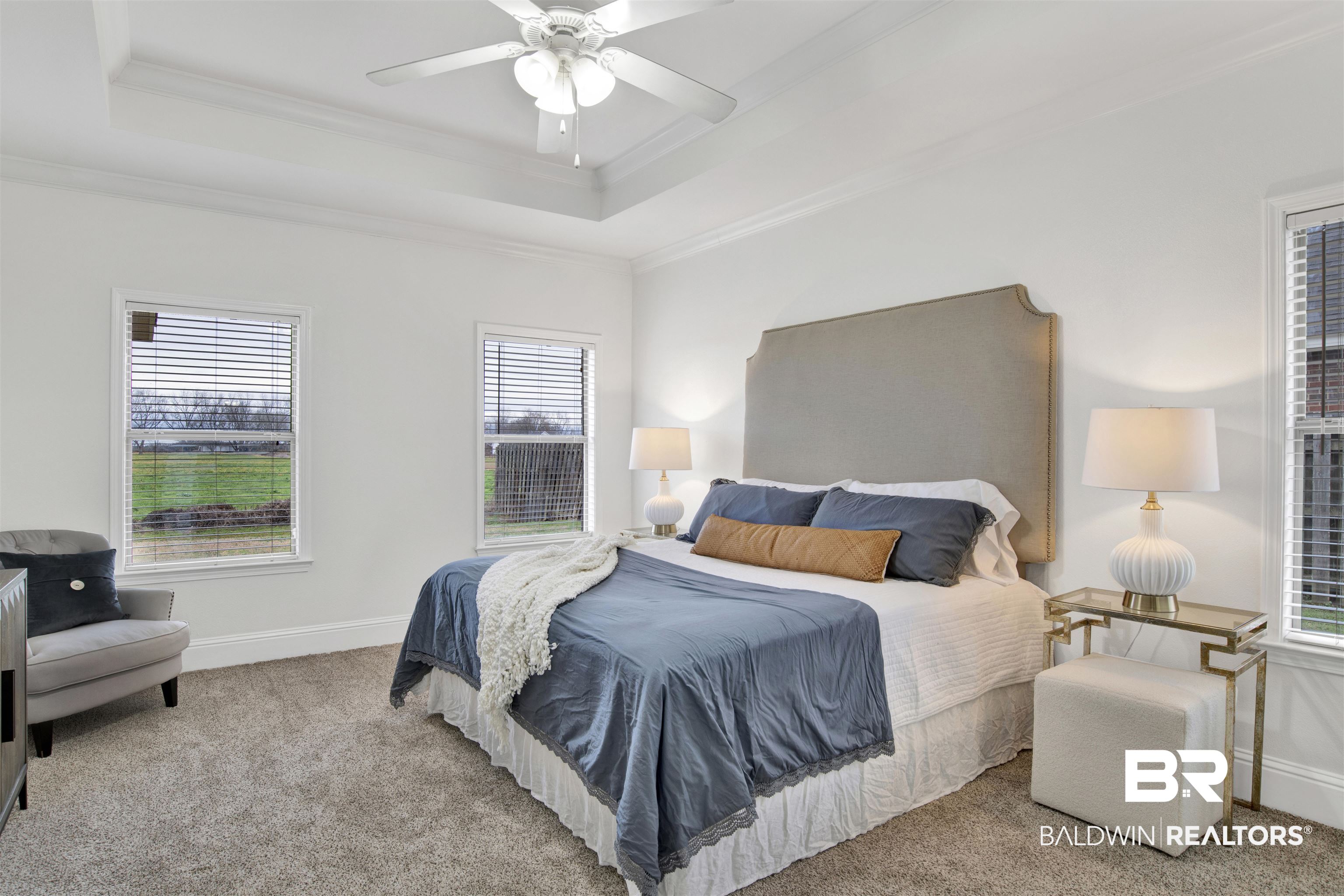 25350 Spindle Lane Daphne, AL 36526 - Photo 16 of 32 Bedroom featuring crown molding, light colored carpet, a raised ceiling, and ceiling fan