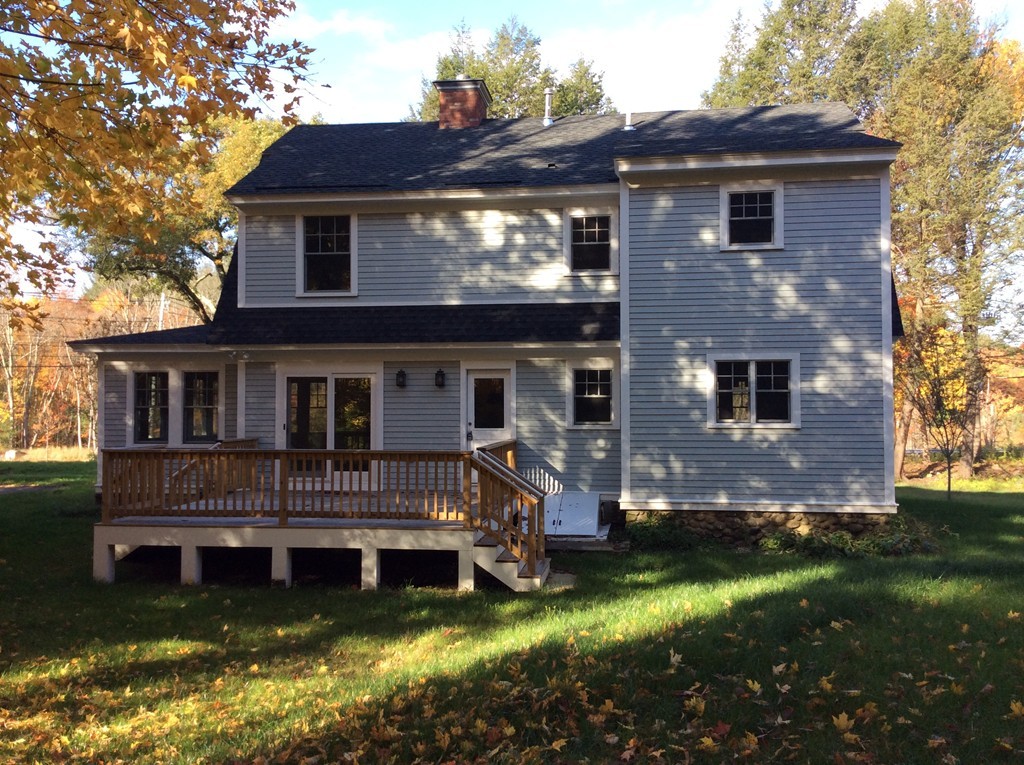 4 Maynard Road Sudbury, MA 01776 - Photo 20 of 22 a view of a house with a yard chairs and a table