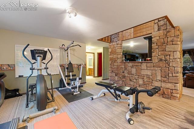 18145 Furrow Road Monument, CO 80132 - Photo 20 of 30 This open area off the basement bar area is currently in use as a home gym.