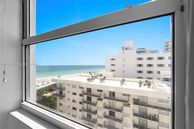 a living room with furniture and large windows