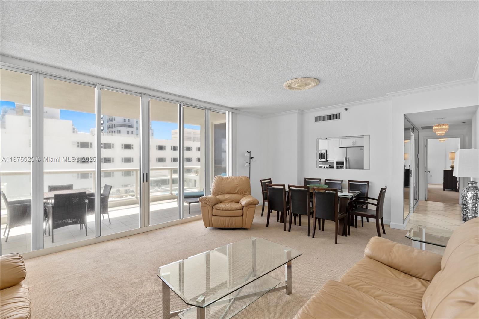 4201 Collins Avenue, Unit 701 Miami Beach, FL 33140 - Photo 13 of 61 a living room with furniture and large windows