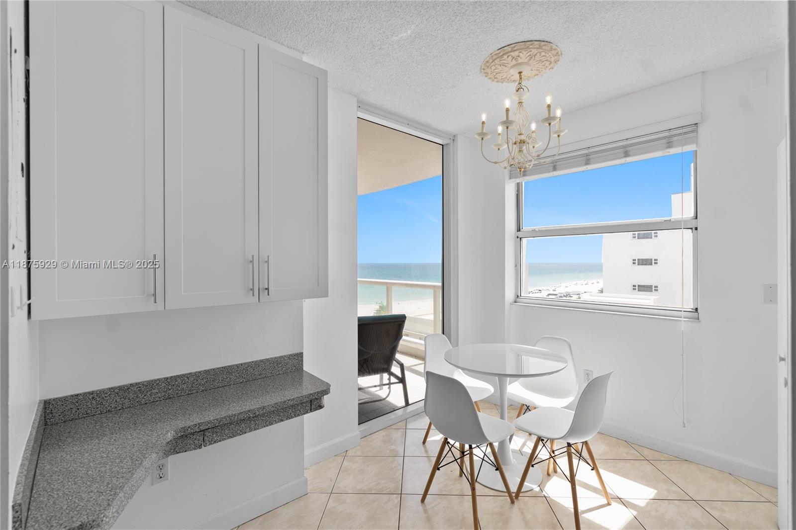4201 Collins Avenue, Unit 701 Miami Beach, FL 33140 - Photo 15 of 61 a view of a dining room with furniture and chandelier