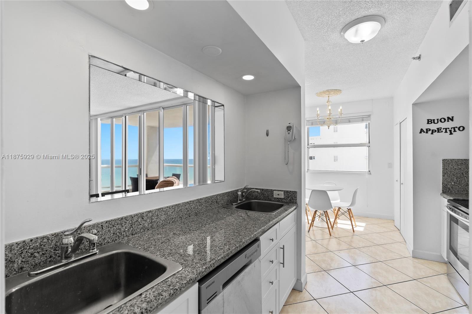 4201 Collins Avenue, Unit 701 Miami Beach, FL 33140 - Photo 17 of 61 a kitchen with a sink and a stove top oven