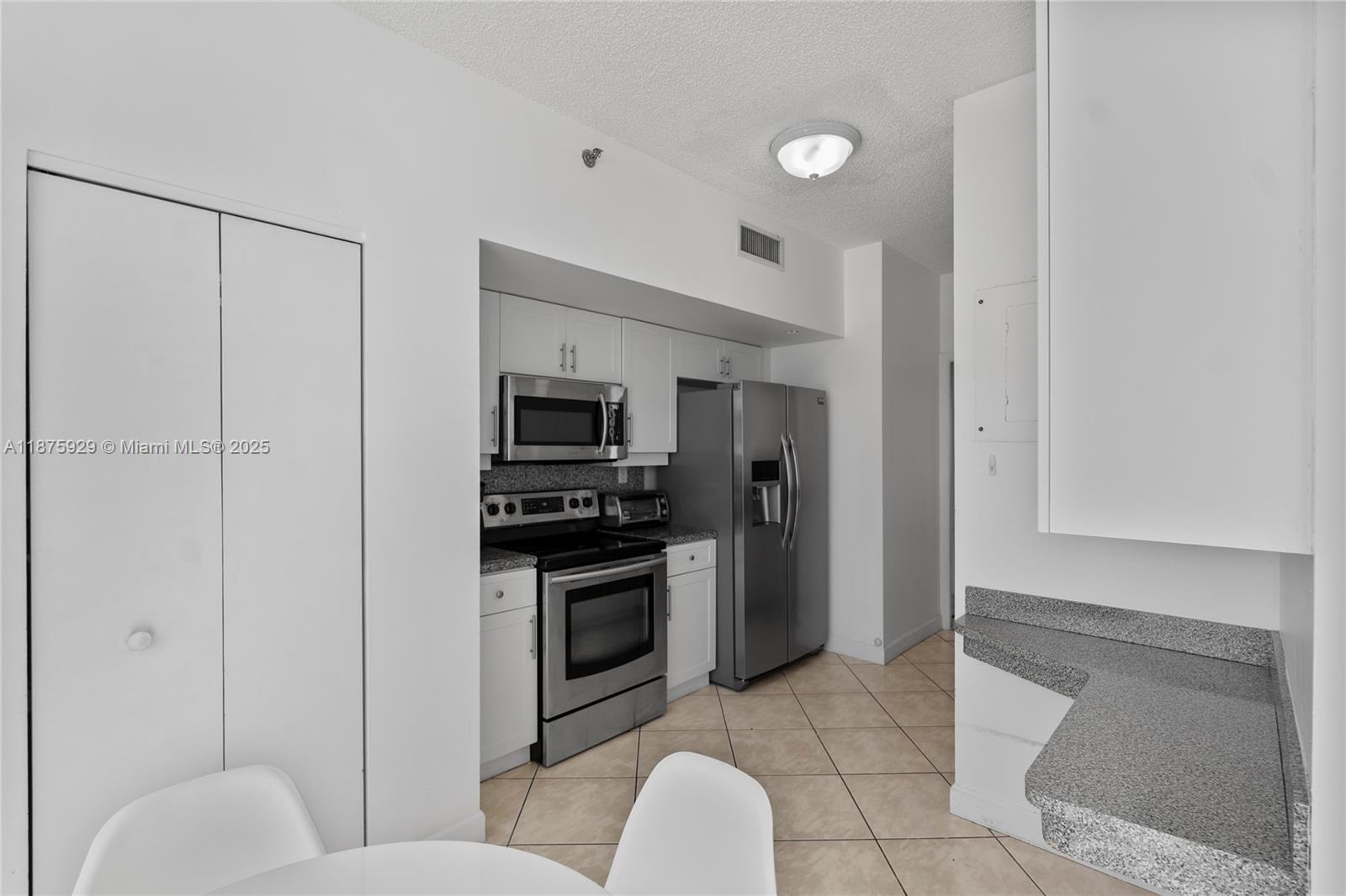 4201 Collins Avenue, Unit 701 Miami Beach, FL 33140 - Photo 19 of 61 a kitchen with stainless steel appliances granite countertop a refrigerator and a sink