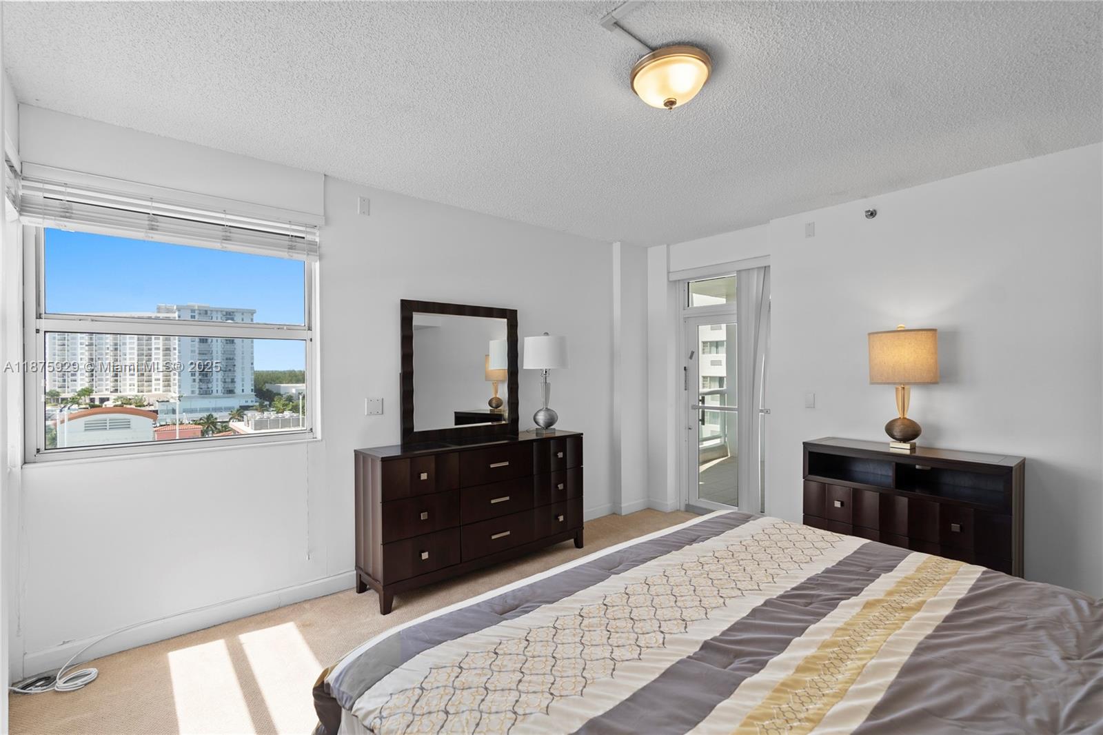 4201 Collins Avenue, Unit 701 Miami Beach, FL 33140 - Photo 22 of 61 a bedroom with a bed and a dresser