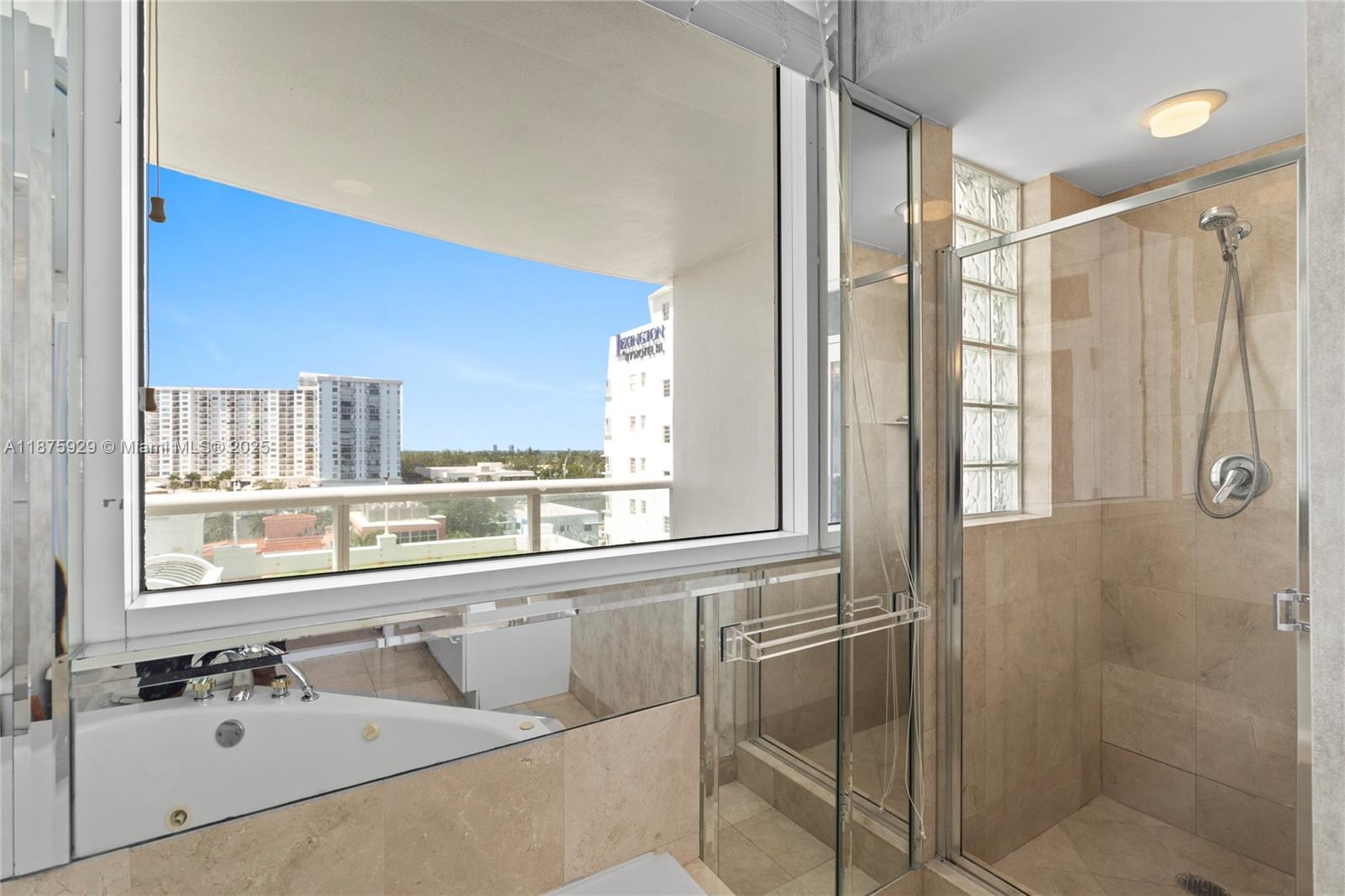 4201 Collins Avenue, Unit 701 Miami Beach, FL 33140 - Photo 26 of 61 a bathroom with a shower sink and mirror