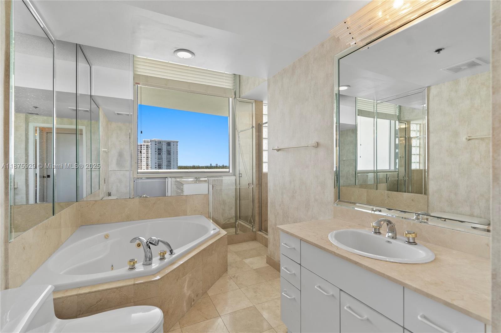 4201 Collins Avenue, Unit 701 Miami Beach, FL 33140 - Photo 27 of 61 a bathroom with a tub a sink and mirror