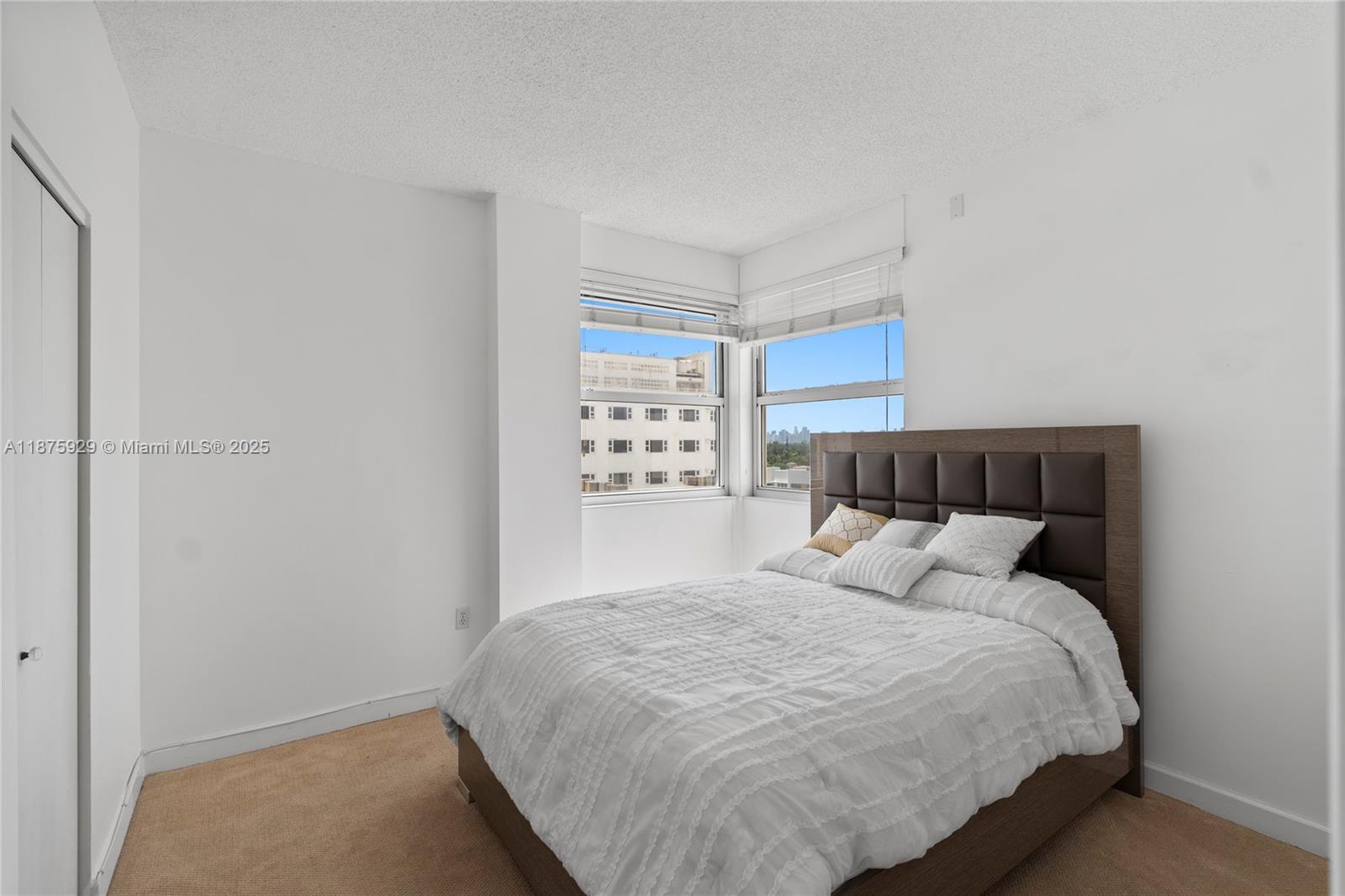 4201 Collins Avenue, Unit 701 Miami Beach, FL 33140 - Photo 28 of 61 a bedroom with a bed and a window