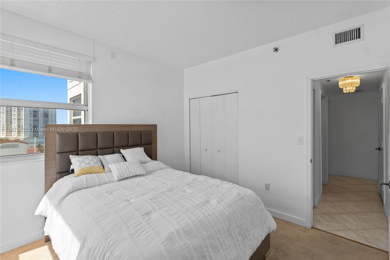 4201 Collins Avenue, Unit 701 Miami Beach, FL 33140 - Photo 29 of 61 a bedroom with a bed and window