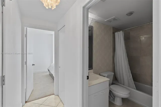 a bathroom with a toilet a sink and a mirror