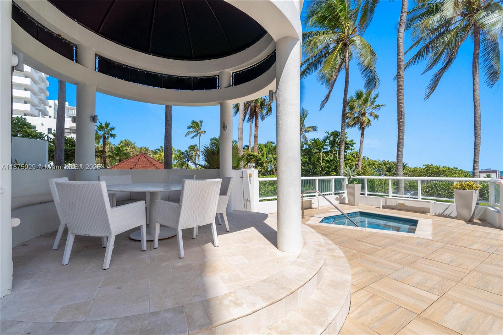 4201 Collins Avenue, Unit 701 Miami Beach, FL 33140 - Photo 52 of 61 a view of a patio with a table and chairs