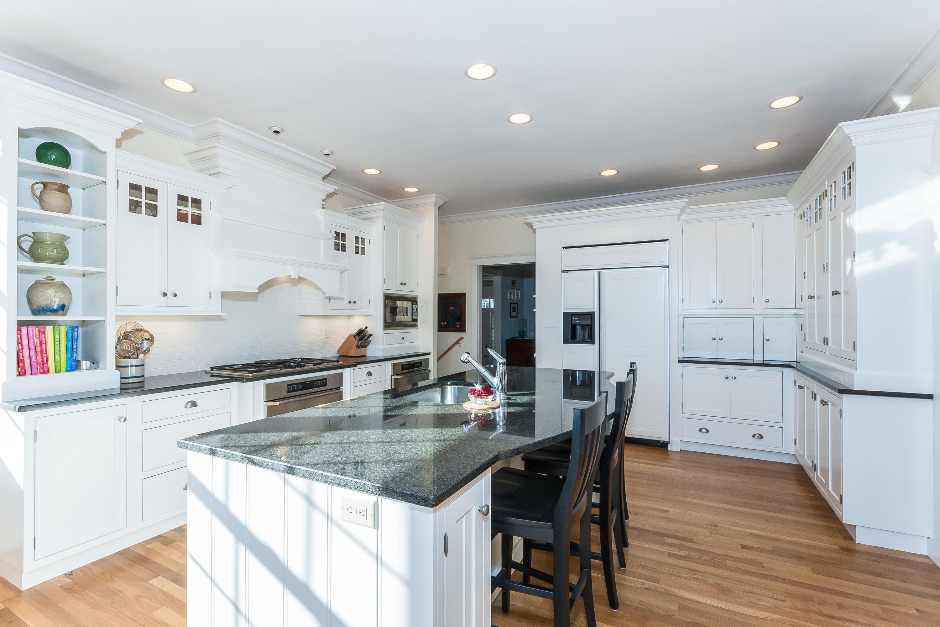 26 Stanton Road Darien, CT 06820 - Photo 13 of 40 a kitchen with granite countertop a table chairs stove and cabinets
